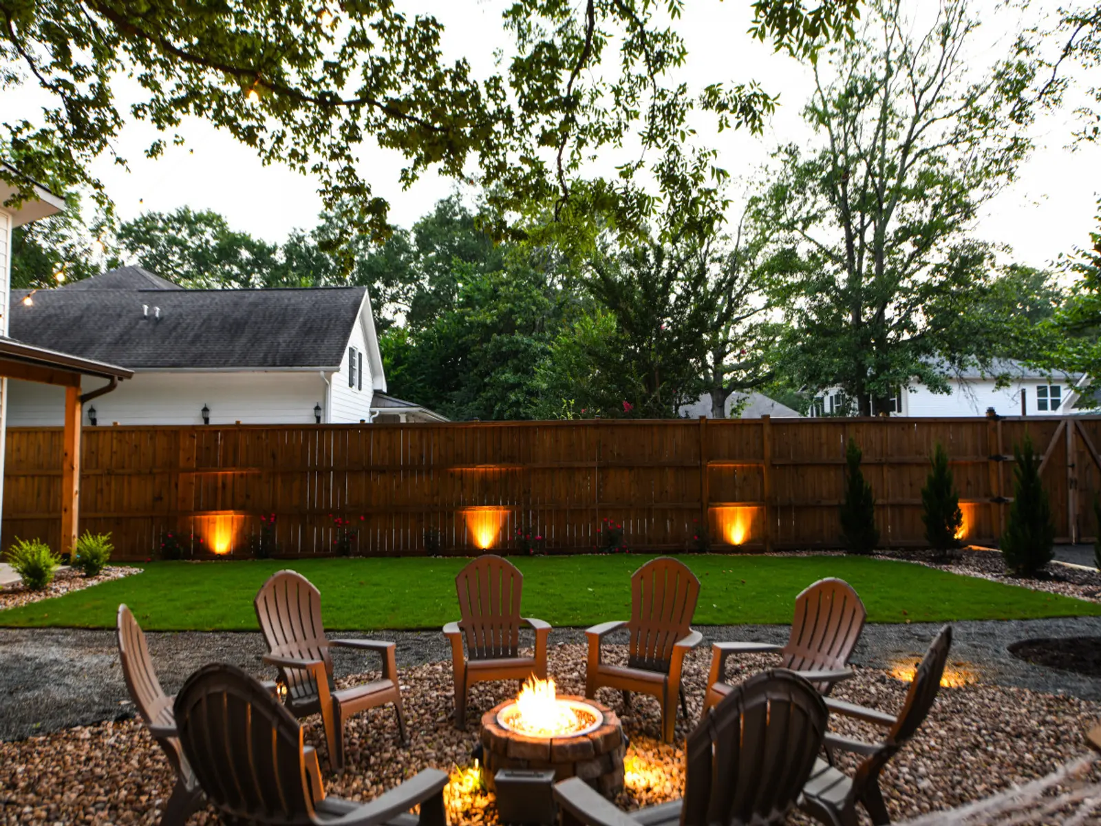 Shared backyard fire pit and lawn at golden hour