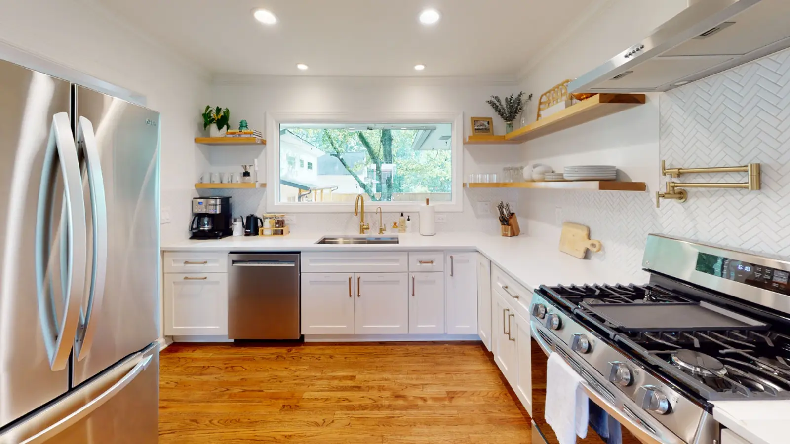 Crossing House kitchen with stainless appliances and a window over the sink