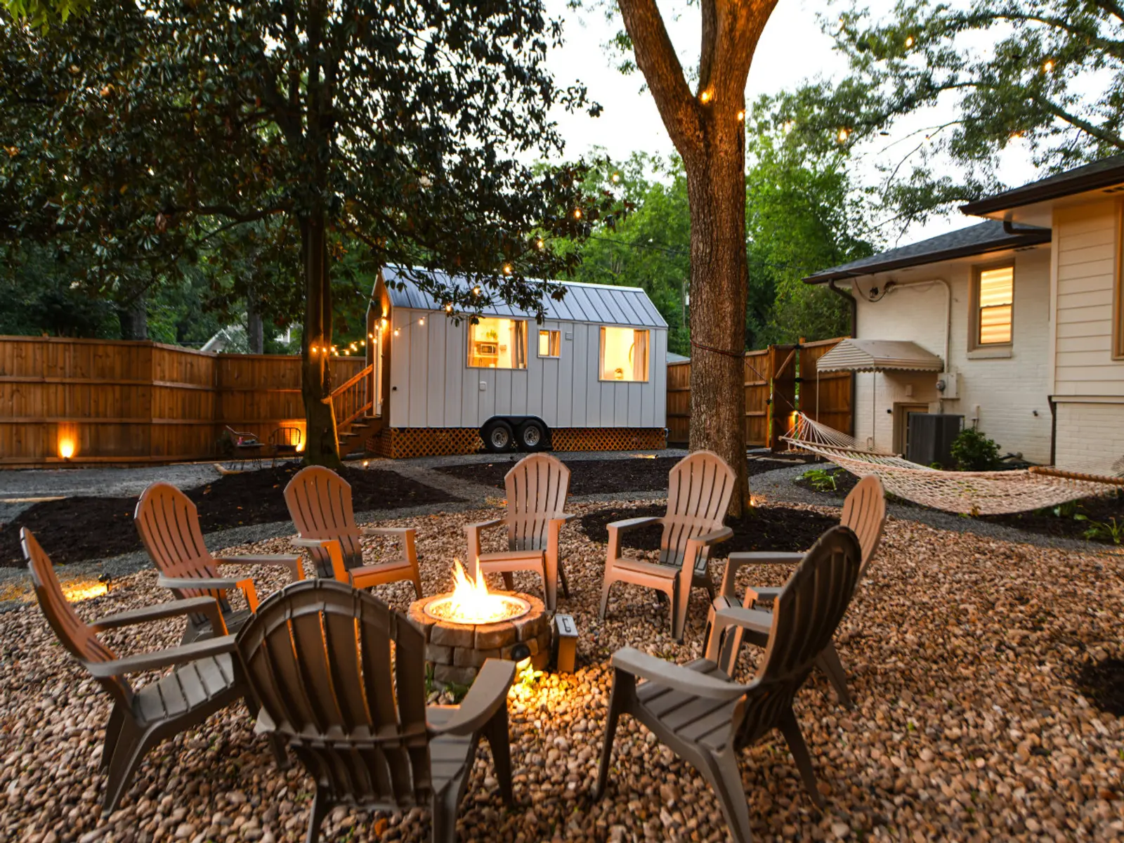 Fire pit circle with the Magnolia Mini tiny home in the background
