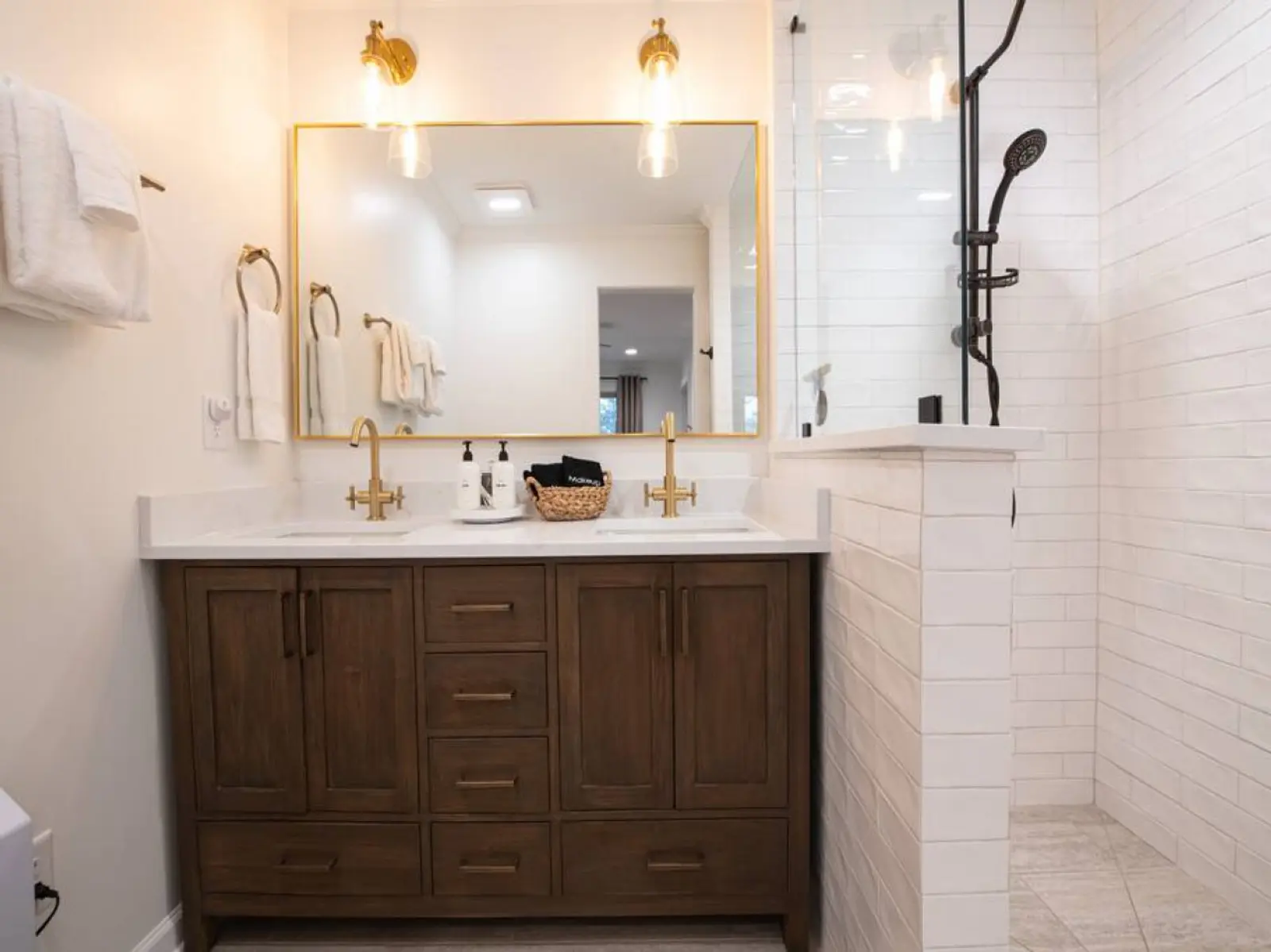 Crossing House bathroom with a double vanity and walk-in shower